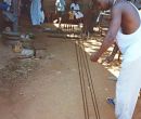 Seth laying out the warp in the front of the family compound. His nieces and nephews are in the background.